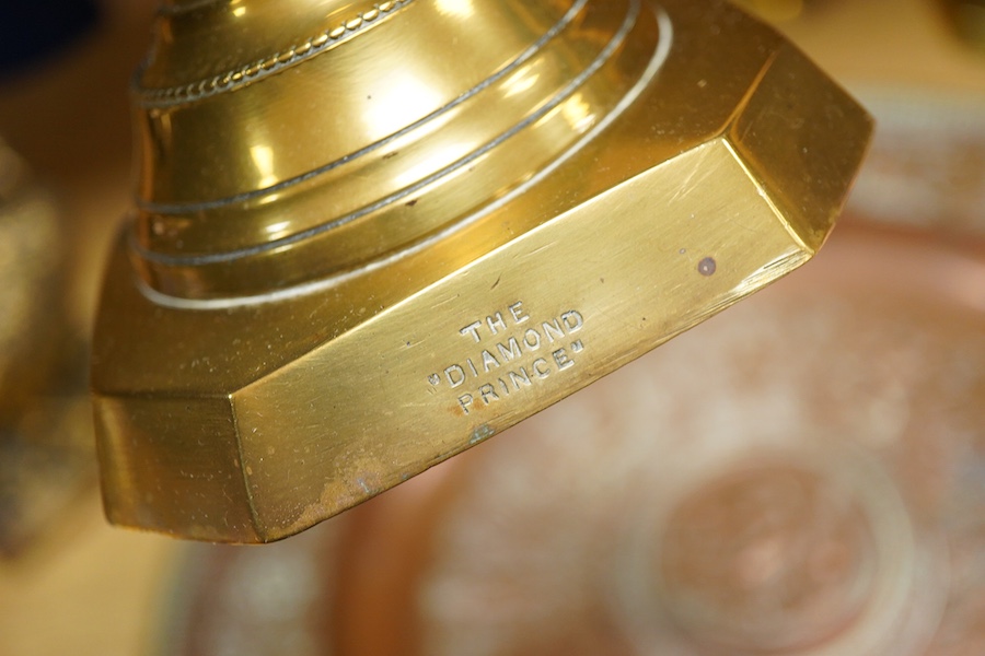 A group of copper and brassware to include candlesticks and an alms dish, 45cm in diameter